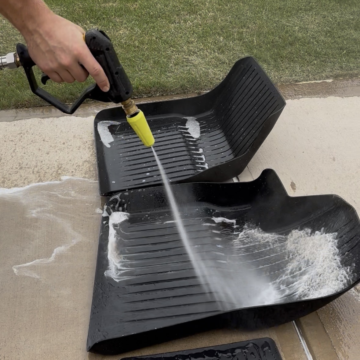 Pressure washing floor mats during a mobile detail